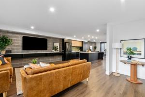 a living room with a couch and a tv at Downtown House in Geelong