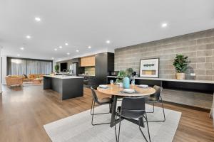 a kitchen and living room with a table and chairs at Downtown House in Geelong