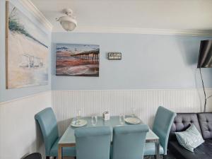 a dining room with a table and chairs at Victorian 3101- Paradise Cove in Galveston