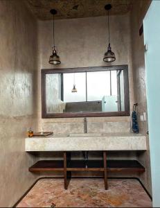 een badkamer met een wastafel en een spiegel bij Casa IxeYolo in Amatlán