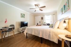 a bedroom with a bed and a flat screen tv at Renovated Studio - Steps to Beach, POOL, & Cabana! in Panama City Beach