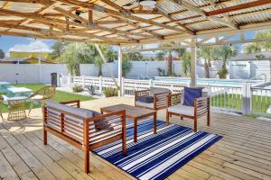 a patio with a table and chairs under a pavilion at Renovated Studio - Steps to Beach, POOL, & Cabana! in Panama City Beach