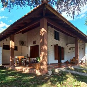 a view of a house with a patio at Cabañas Tres Ríos Vacacional in Villa Cura Brochero