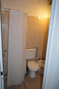 a bathroom with a toilet and a shower curtain at Cabañas Tres Ríos Vacacional in Villa Cura Brochero +39 photos