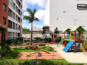 a playground in a park in front of a building at Apartamento completo in Manaus