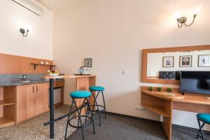 a kitchen with a counter and stools in a room at Lotus Family Hotel - Free Parking in Sunny Beach