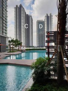 a large swimming pool in a city with tall buildings at Alpine Conezion Golf View Netflix at IOI City Mall in Putrajaya