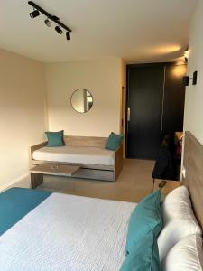 a bedroom with a bed with blue pillows and a mirror at Departamento Rivadavia in Mar del Plata