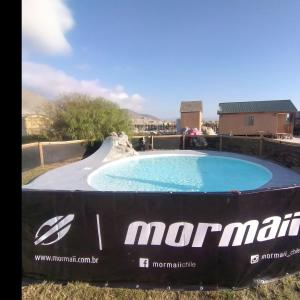 a large swimming pool with a ramp in a yard at Portofino Surf Camp in Ciudad de Chañaral