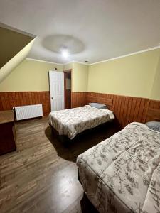 a hotel room with two beds and a ceiling at Casa Recinto in Recinto