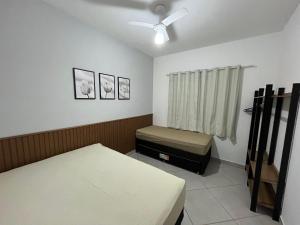 a hospital room with two beds and a window at Rafael Apartamentos 800m da Praia da Maranduba in Ubatuba
