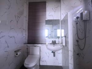 a white bathroom with a toilet and a sink at How Hide Space in Kanchanaburi +12 photos