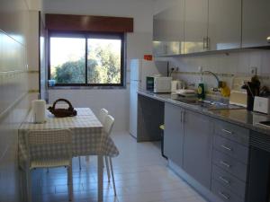 a kitchen with a table and a table and chairs at 1Bed Tagus River View in Alhandra