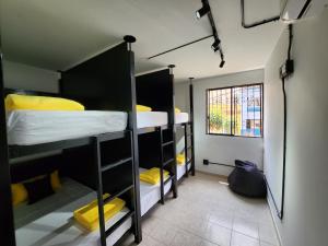 a room with three bunk beds and a window at PRADO DOWNTOWN in Medellín