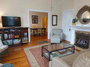 a living room with a tv and a fireplace at Urban Cottages in Little Rock