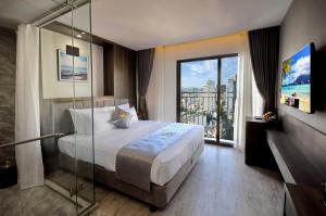 Postel nebo postele na pokoji v ubytování Ivy Hotel Nha Trang