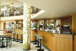 a bar in a restaurant with tables and chairs at Eurotel in Grottammare