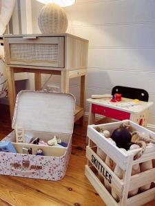 a toy room with a table and some boxes at Port Douglas Beach Cottage in Port Douglas