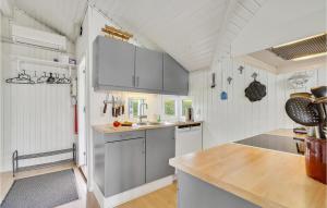 a kitchen with white cabinets and a counter top at Holiday Home Vesterbakken Assens Ii in Assens