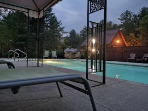 a swimming pool with a table and a chair next to it at Westwind Inn on the Lake in Buckhorn