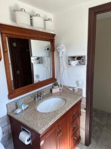 a bathroom with a sink and a mirror at All Star Inn & Suites in Wisconsin Dells