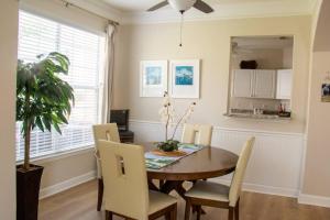 a dining room with a table and chairs at Quiet, Spacious Condo with 2 AWESOME pools and close to the beach in Gulfport