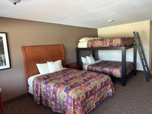 a hotel room with two beds and a bunk bed at All Star Inn & Suites in Wisconsin Dells