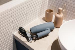 a blow dryer on a bathroom counter next to a sink at ROOM design hotel in Nanao