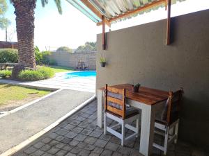 a table and two chairs on a patio at Bosveld In Die Stad 2 Guesthouse in Alberton