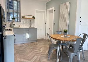 a kitchen and dining room with a table and chairs at ‘Sandy Bottom’ - Apartment by the sea in Combe Martin