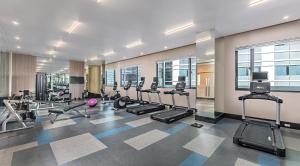 a gym with treadmills and cardio equipment in a building at Seda Residences Makati in Manila