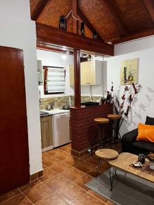 a kitchen and a living room with a couch and a table at Studio Vikendica Bele Vode in Banja Koviljača