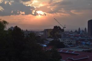 a city skyline at sunset with a crane at Casa 2600 in Bogotá