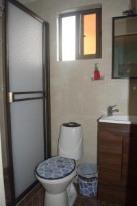 a bathroom with a toilet and a sink at Casa 2600 in Bogotá