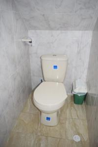a bathroom with a white toilet and a trash can at Casa 2600 in Bogotá