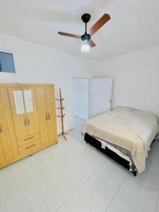 um quarto com uma cama e uma ventoinha de tecto em Casa do Bruno - Apartamento terreo - 1 - Terra - Quarto e sala com cozinha americana na praia do preá-CE em Praia do Preá