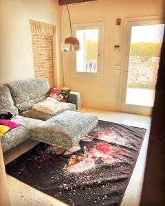 a living room with a couch and a rug at Boutique House Alle Loggie Palladiane di Villa Contarini in Piazzola sul Brenta