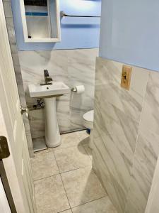 a bathroom with a sink and a toilet at LGA Airport near, Studio walk in bsmt Apt in a Private House! in East Elmhurst