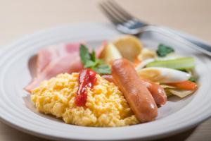 a plate of food with sausage and vegetables on it at Tmark City Hotel Kanazawa in Kanazawa +82 photos