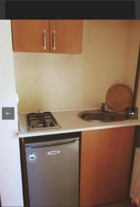 a small kitchen with a stove and a sink at Lake apartments in Struga