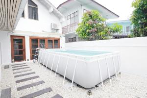 a pool in the courtyard of a house at Ratchada Retreat Boutique Villa 1 in Bangkok