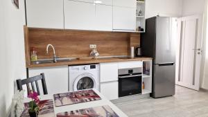 a kitchen with a refrigerator and a washing machine at Lola seaview guest house. Уютный Домик в Варне in Varna City +13 photos