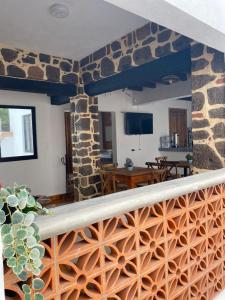 a living room with a stone wall at Hotel La Lejona in San Miguel de Allende