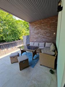 a patio with a couch and a table and chairs at Apartmenthaus am Park in Wilhelmshaven
