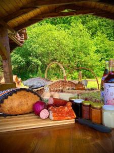 a table with a loaf of bread and some food at Rustic Cottage in Sibiu