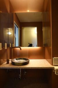 a bathroom counter with a sink and a mirror at the Moto Hotel Asakusa in Tokyo