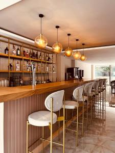 a bar with a row of stools in a restaurant at FİFTY5 SUİTE HOTEL in Marmaris