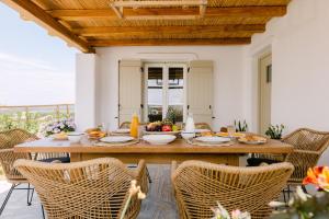 a dining room with a table and chairs at Velonis Villa with private pool and sea view in Agia Anna Naxos