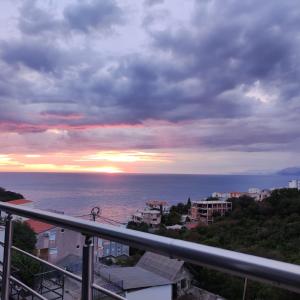 a view of the ocean at sunset from a balcony at Carefree Apartments in Ulcinj