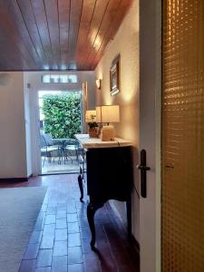 a hallway with a table with a lamp on it at Holiday Home Dunja in Opatija